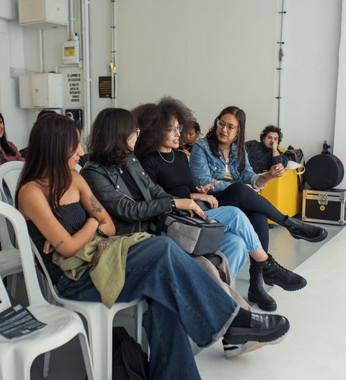 Group of diverse people smiling and sitting with yoga mats.