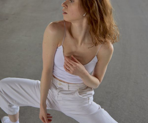 Woman performing a graceful yoga flow in a calm environment.